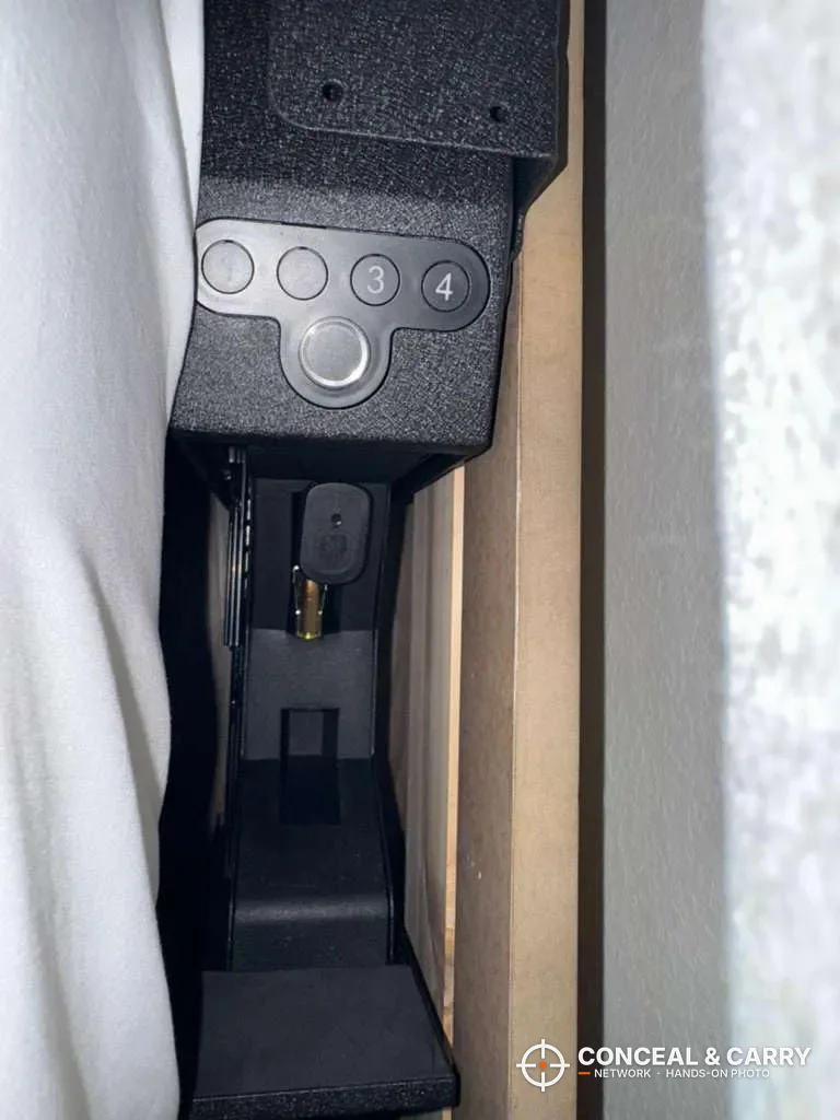 Top-down view of a pistol in the open Langger slider safe drawer