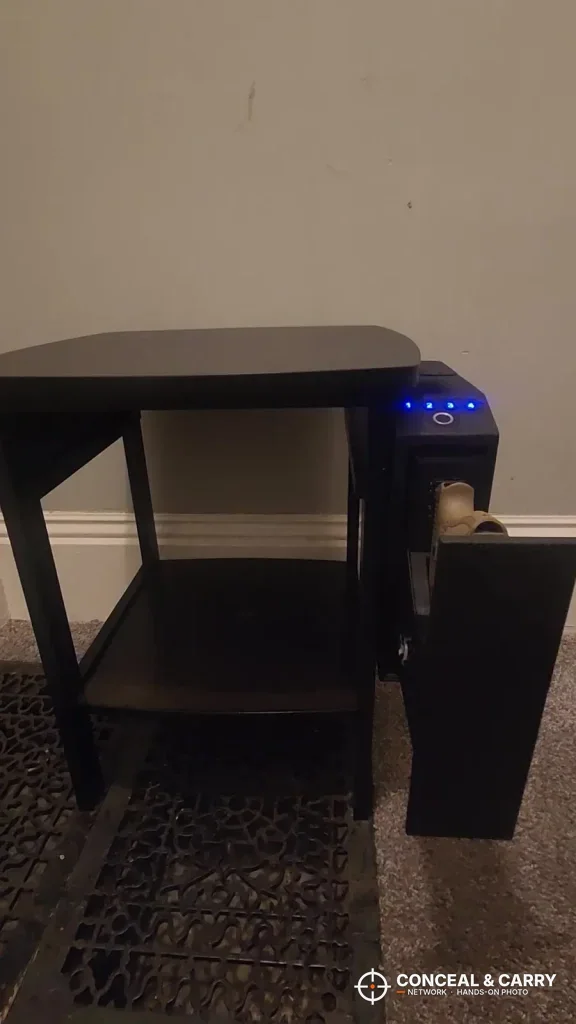 Langger slider safe mounted on the side of a small end table with the keypad lit
