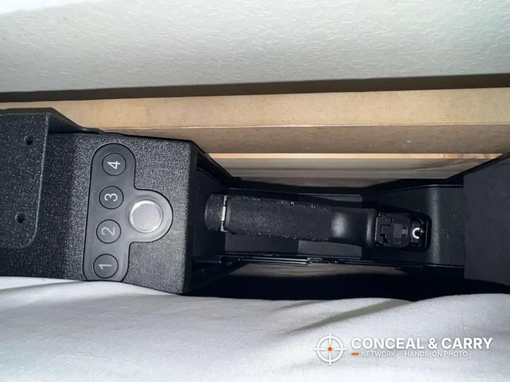 Langger slider safe mounted on its side with the drawer open and a pistol inside