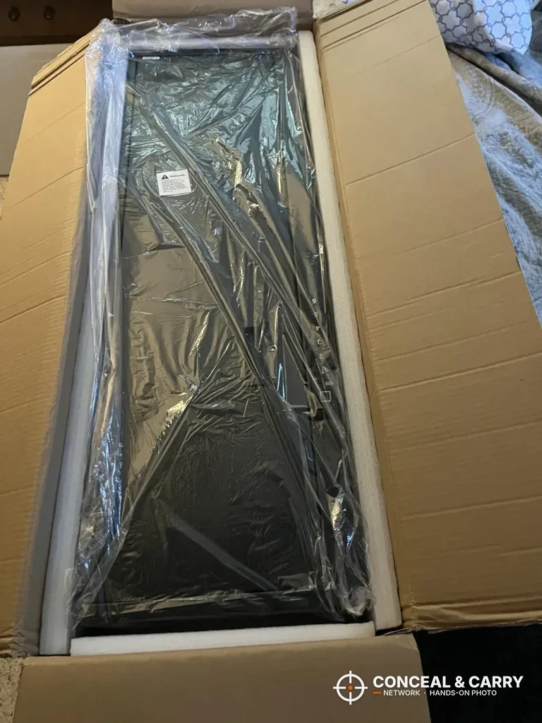 Langger compact long gun safe wrapped in plastic inside its shipping box