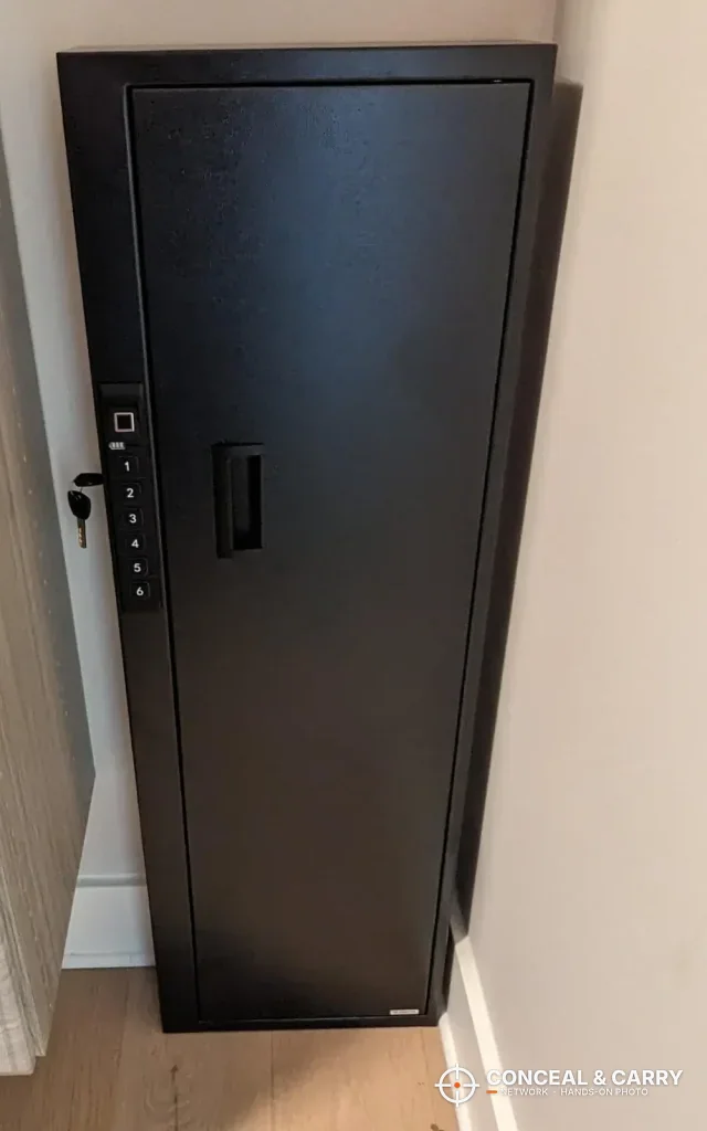 Langger compact long gun safe standing closed in a room corner