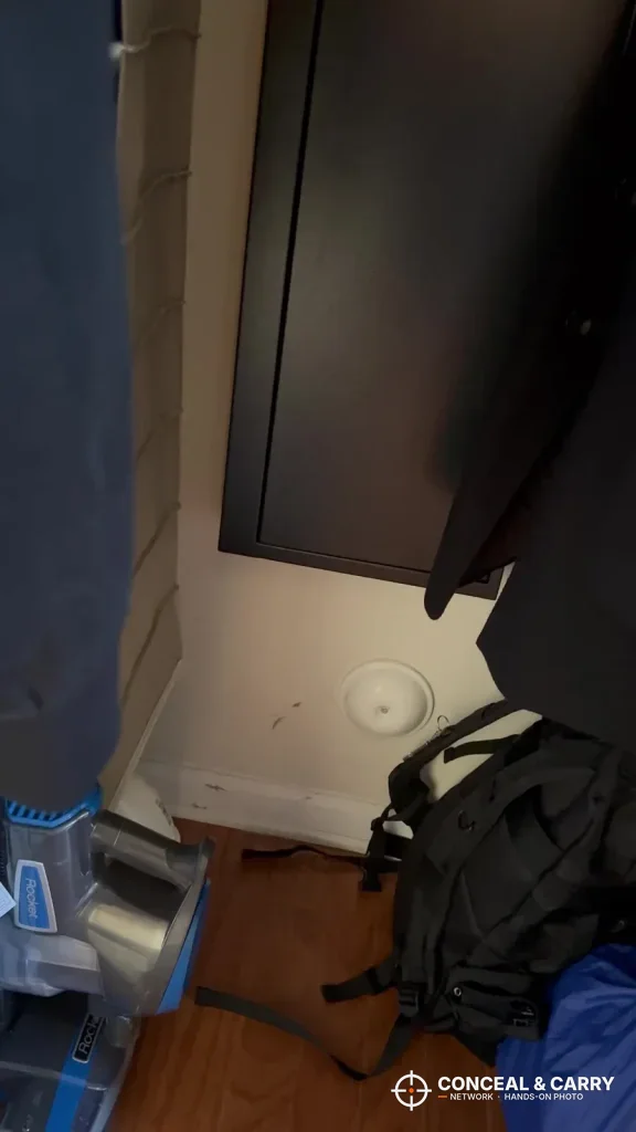 Langger compact safe mounted high on a wall above a backpack