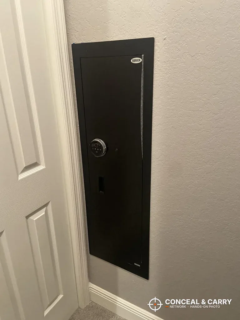Black Langger in-wall safe recessed into the wall next to a door frame
