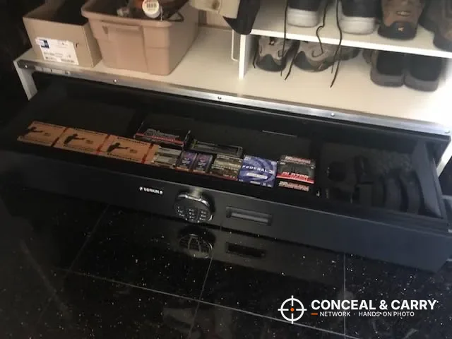 Langger under-bed safe drawer open with ammunition boxes inside, under a closet shelf