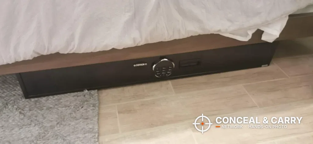Langger under-bed gun safe closed under a bed frame with the keypad on the front