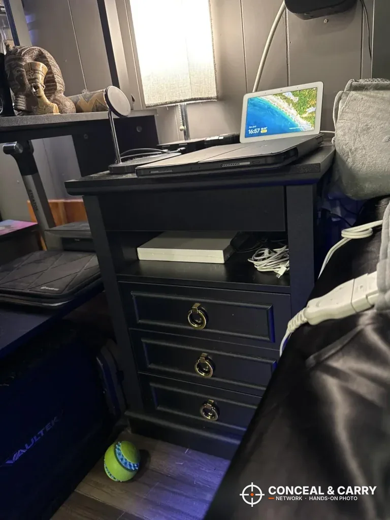 Lvifur nightstand beside a bed with a lamp and laptop on top