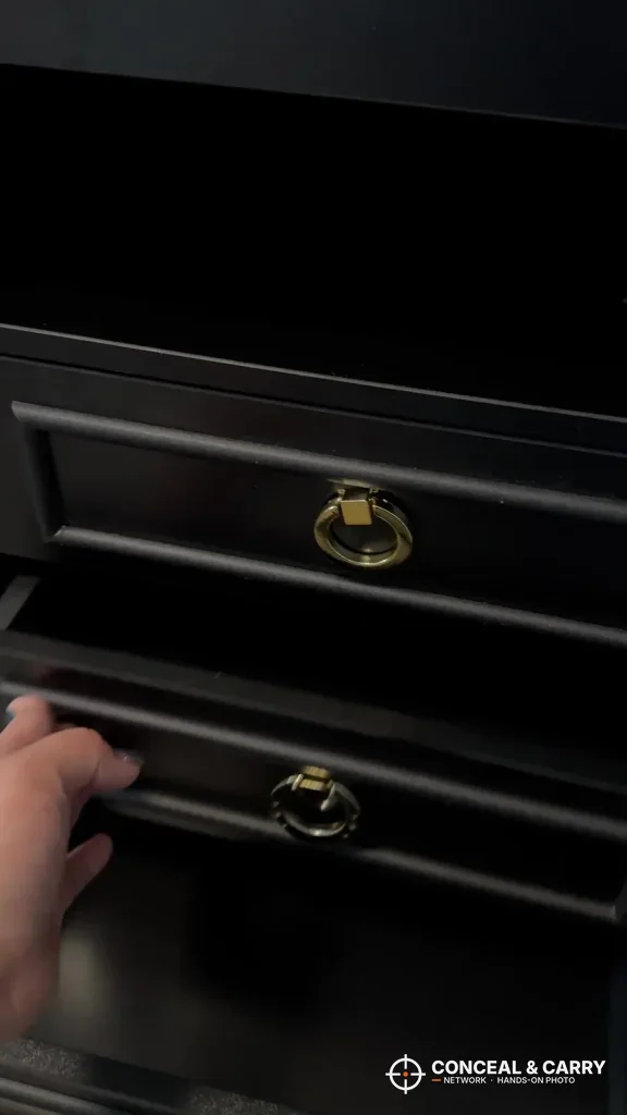 Hand pulling open a Lvifur drawer by its gold ring pull