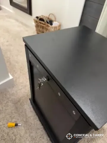 Lvifur nightstand seen from the side with a screwdriver on the floor