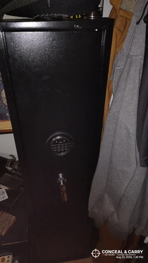 Marcree 8-10 gun safe in a closet beside hanging clothes