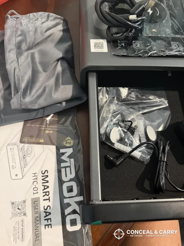 Mboko smart safe box with bagged accessories in the open drawer