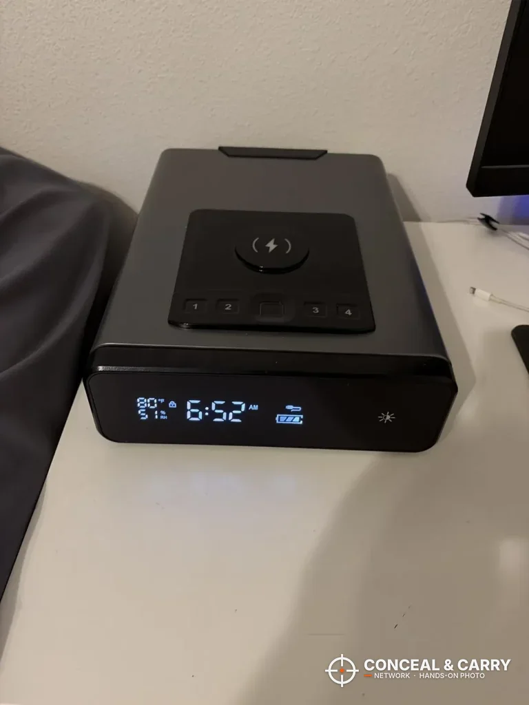 Mboko biometric safe on a white nightstand beside a bed