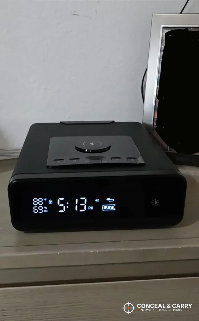 Mboko bedside safe on a nightstand with the clock lit