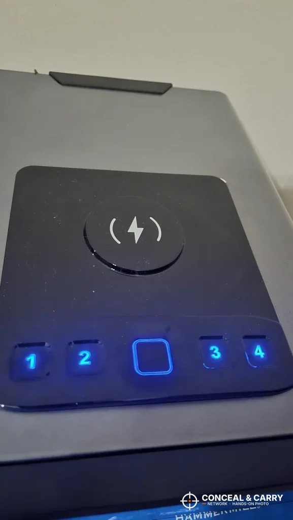 Mboko touch keypad lit blue under the wireless charging pad