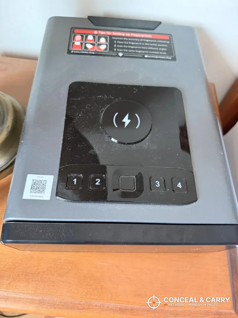 Top of the Mboko safe with the charging pad, keypad and warning label