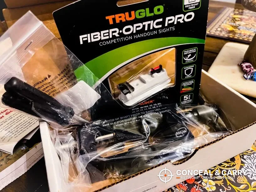 MGW Glock sight tool in its shipping box next to a pack of TruGlo fiber-optic sights