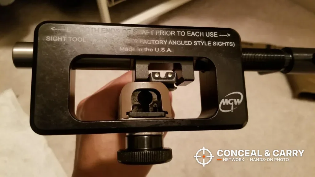 MGW Glock sight tool frame with a slide clamped and the rear sight showing through the window