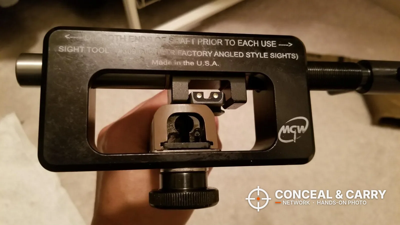 MGW Glock sight tool frame with a slide clamped and the rear sight showing through the window