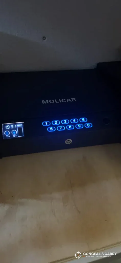 MOLICAR safe keypad and screen lit up in a dark room