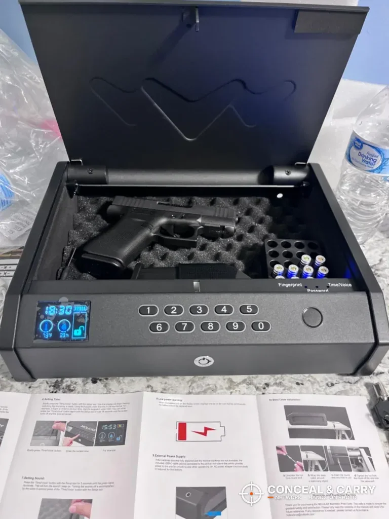 MOLICAR safe open with a pistol inside and the manual in front