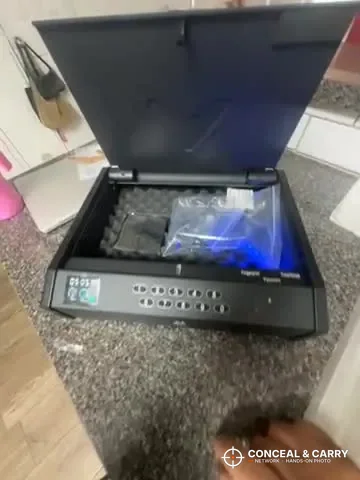 MOLICAR bedside safe opened with a plastic bag sitting on the foam