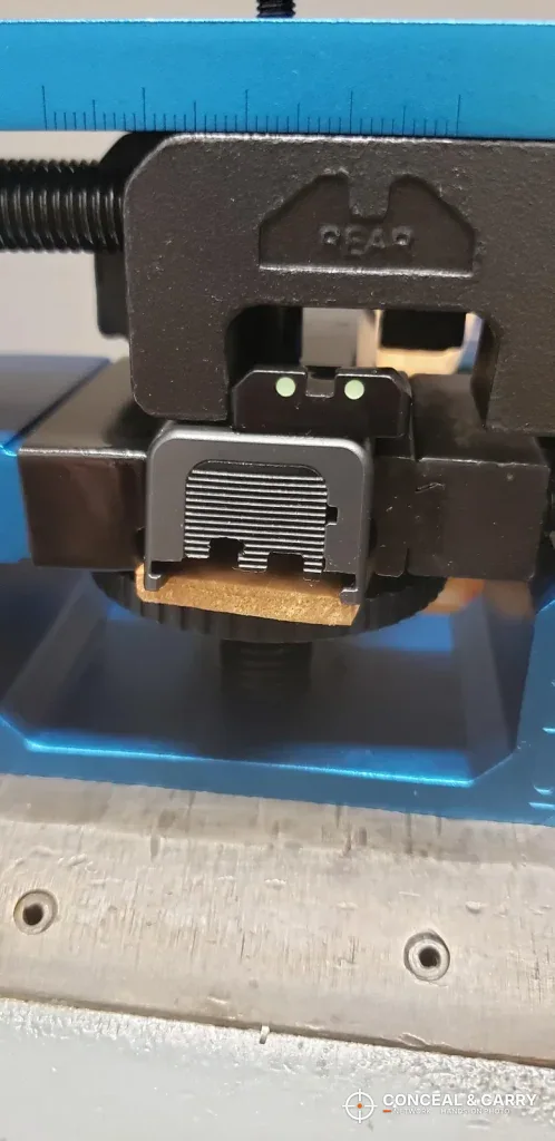Rear sight in the slide dovetail with the NcSTAR VISM push block behind it