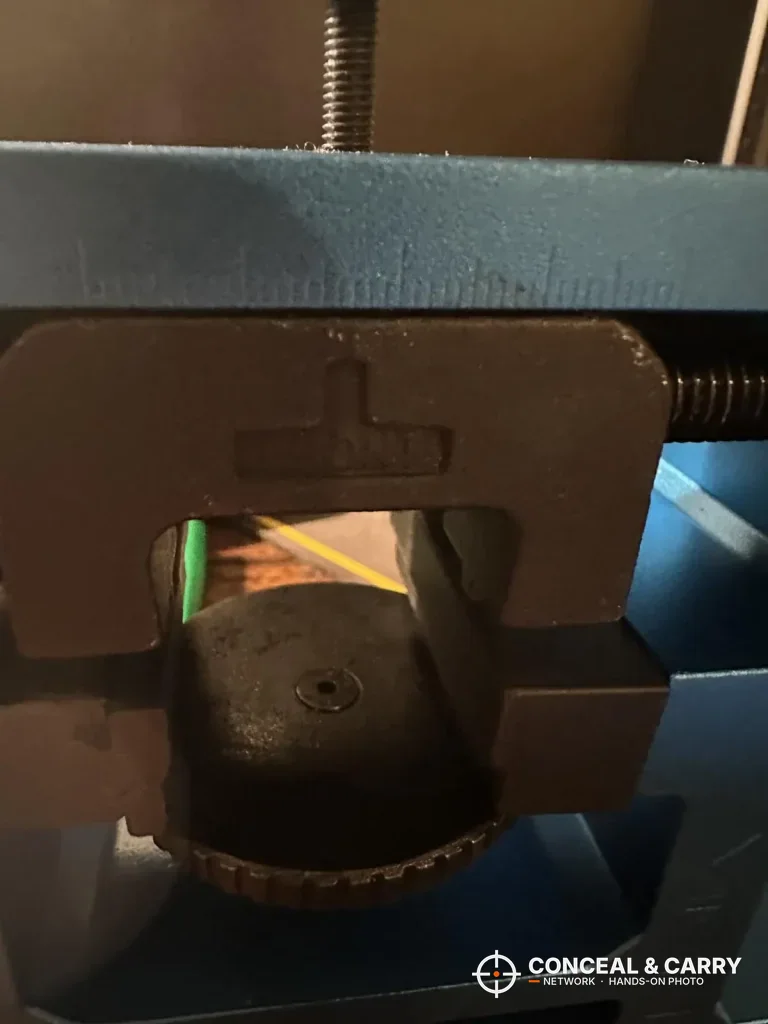 Close-up of the NcSTAR VISM push block against a sight with a green fiber