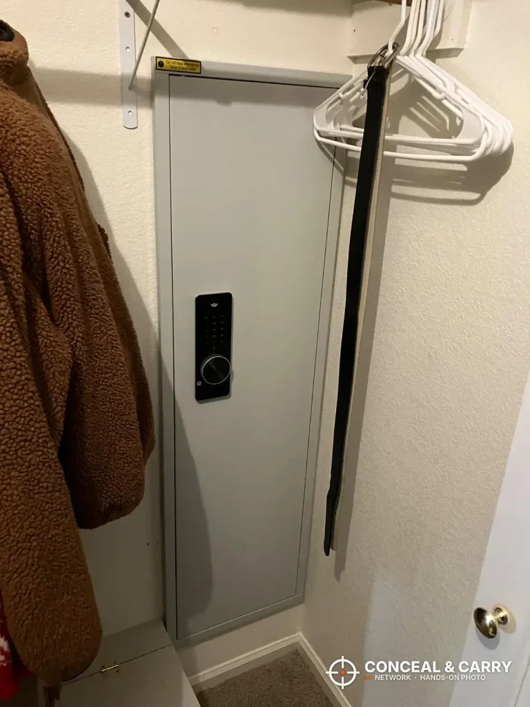 Omethey in-wall biometric safe closed in a closet with the keypad on the door