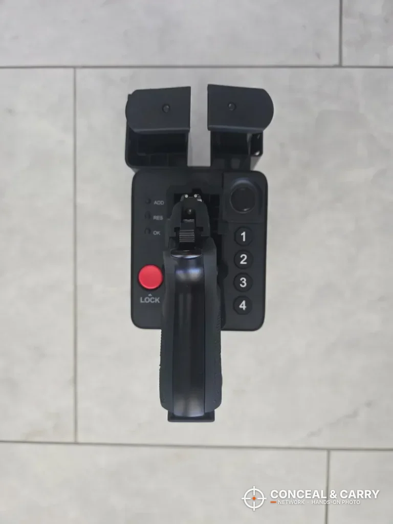 Top view of the ONNAIS open-design safe holding a pistol