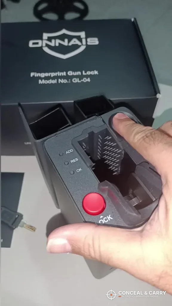 Hand holding the ONNAIS open-design safe in front of its box