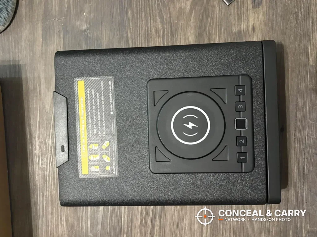 Top view of the ORARAER safe showing the charging pad, button row and instruction label