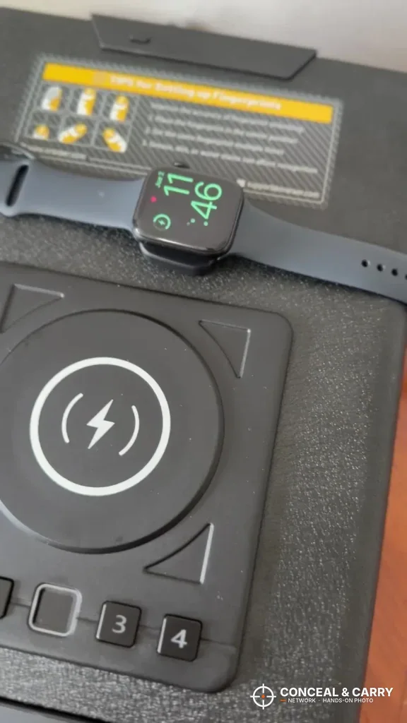 Close-up of the ORARAER safe 3 and 4 keys below the charging pad, with a smartwatch on top