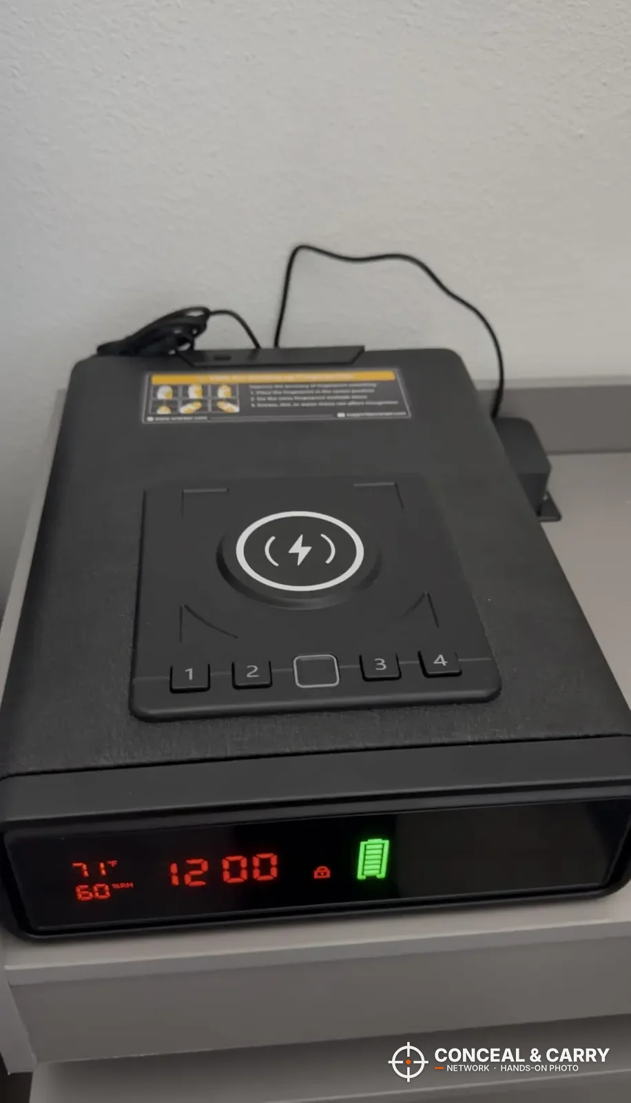 ORARAER smart charging gun safe on a nightstand with the clock lit and the power cord plugged in
