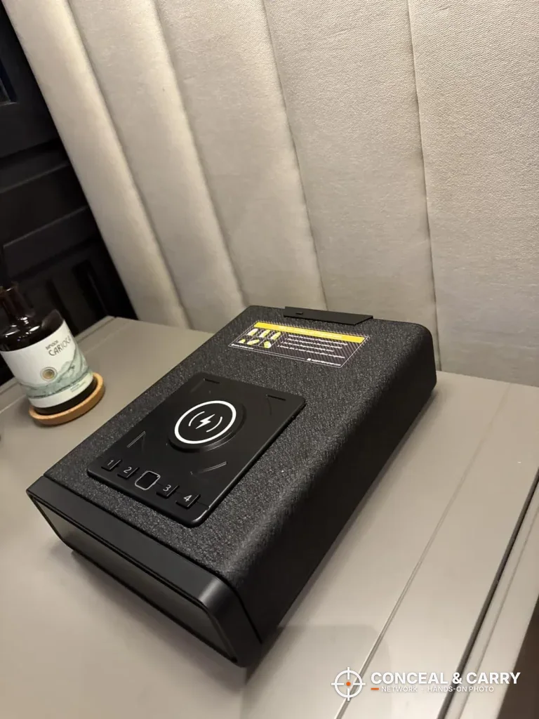 ORARAER smart charging gun safe on a gray nightstand, angled to show the steel case