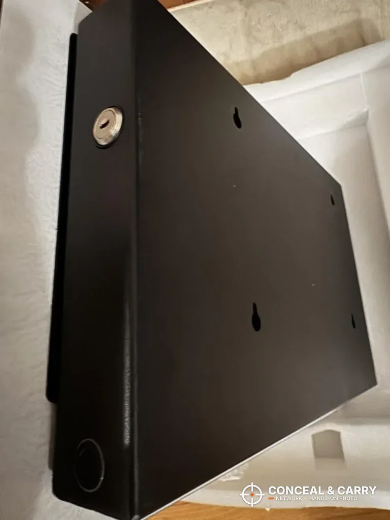 Back of the PJJSZST safe case with keyhole mounting slots and the side key lock