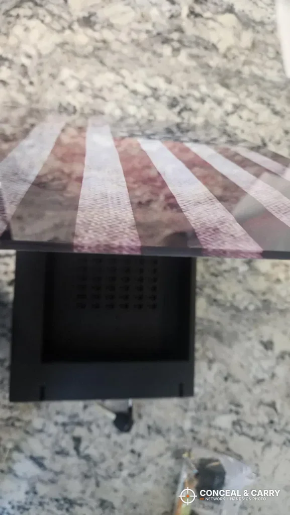 PJJSZST hidden wall safe with the flag front lifted to show the interior