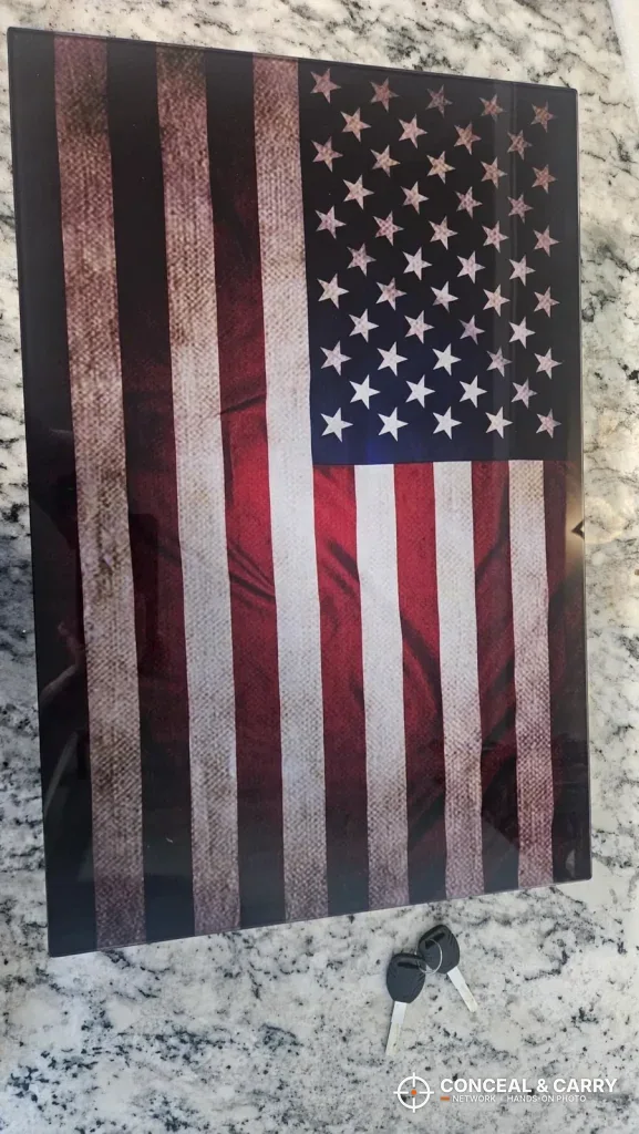 PJJSZST flag wall safe lying face up with its two keys