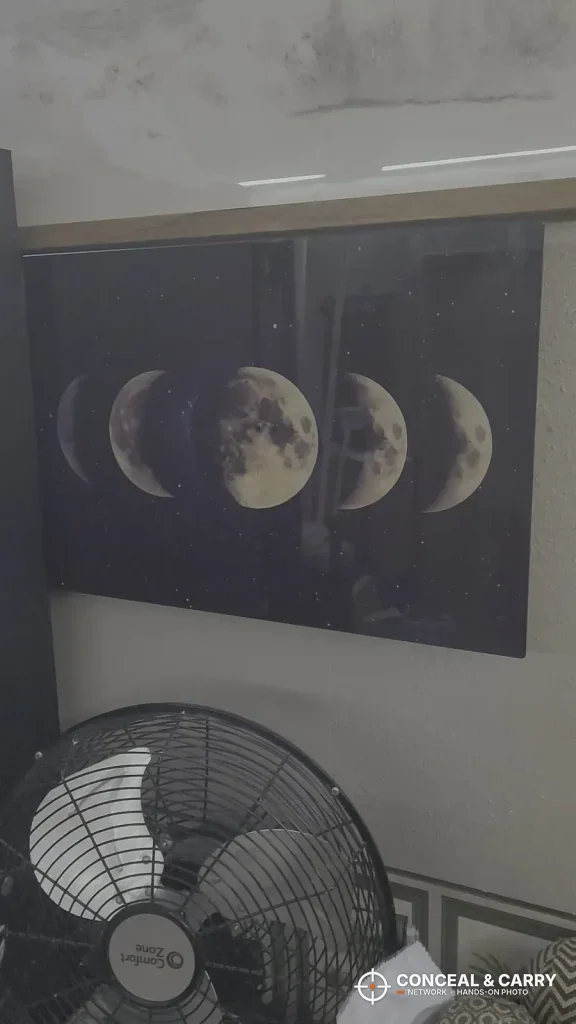 Moon-phase print wall safe in the PJJSZST style hung above a fan