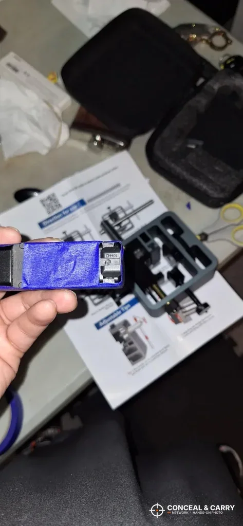 Pridefend Glock sight pusher unpacked on its instruction sheet with the carry case behind it
