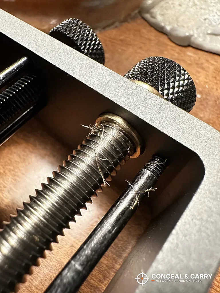 Close-up of the Pridefend sight pusher drive screw and knurled knobs