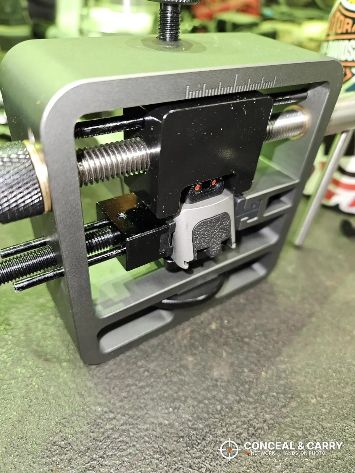 Pridefend Glock sight pusher on a workbench with a slide clamped in place