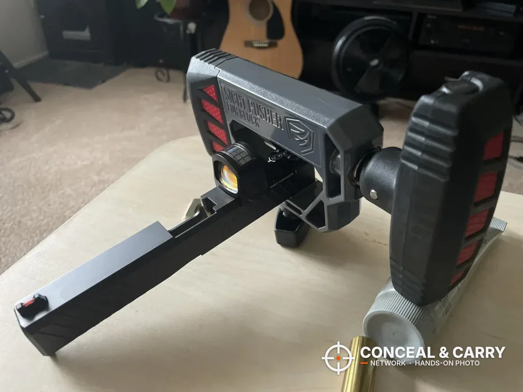 Real Avid Glock sight pusher with a Glock slide clamped in place