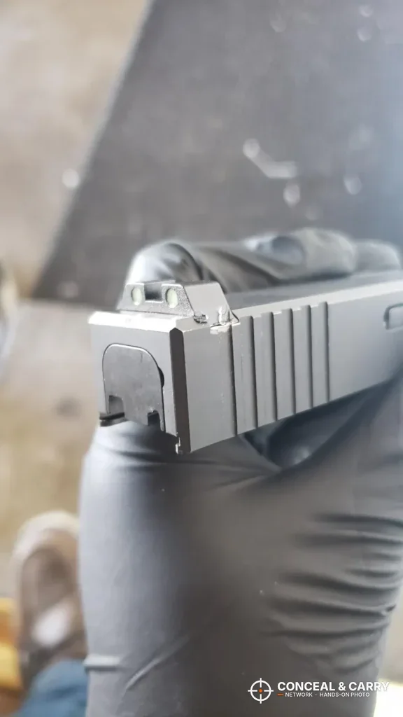 Glock slide viewed from behind to check rear sight center, a Real Avid sight pusher step