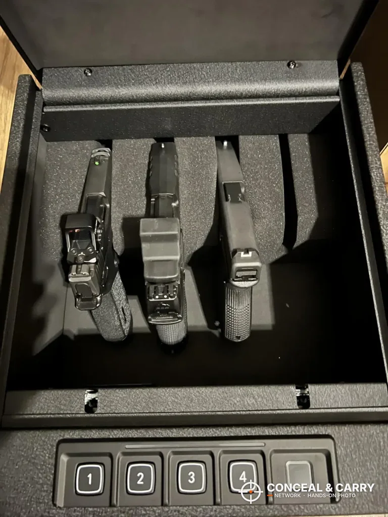 Three pistols in the RPNB 4-pistol safe foam rack above the keypad