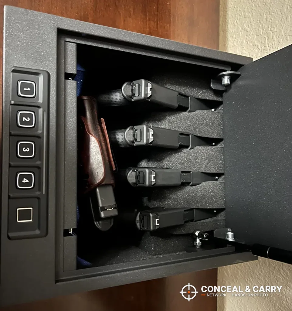 RPNB 4-pistol safe on its side with the lid swung open and four pistols racked
