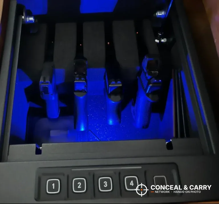 RPNB 4-pistol biometric safe open with four pistols in the blue-lit foam rack