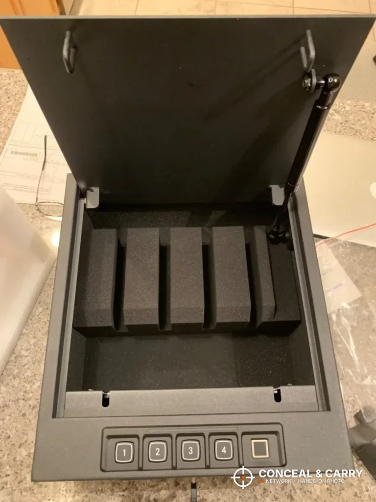 RPNB 4-pistol safe open on a counter with the empty foam rack and lid strut