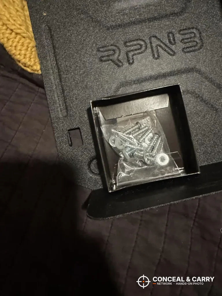 Screws and washers in a small tray on the RPNB bedside safe bracket