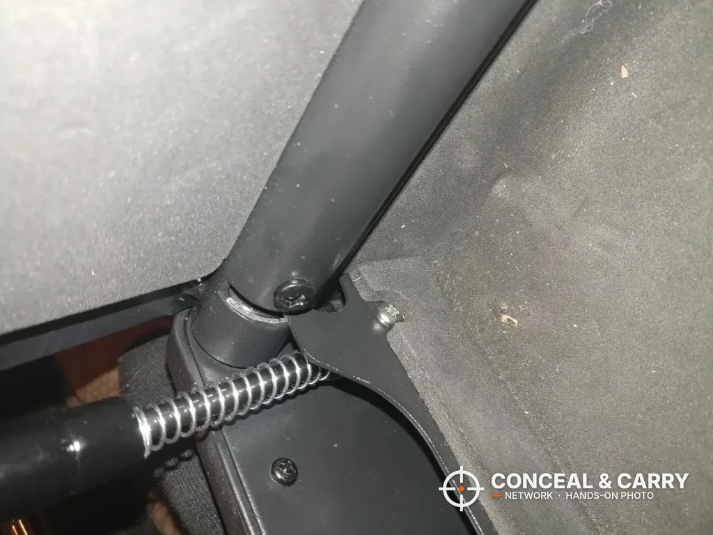 Close-up of the SentrySafe QAP2E gas strut and coil spring at the lid hinge