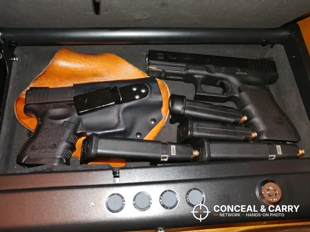 Two pistols, a holster and four magazines inside the SentrySafe QAP2E