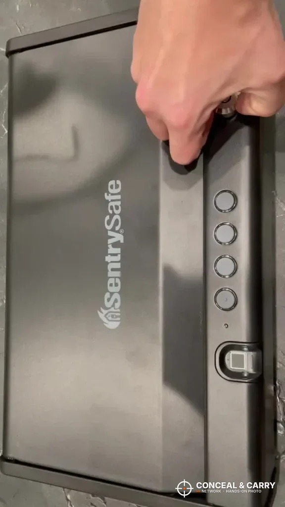 Hand holding the SentrySafe QAP2BLX on its end